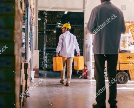 stock-photo-two-men-working-in-the-storage-selective-focus-on-man-with-demijohns-in-hands-1336372217-edit